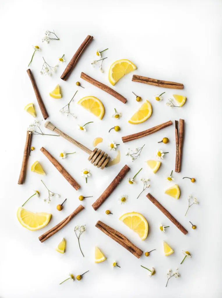 Flatlay of cinnamon sticks, lemon wedges, and flowers | Photo by Heather Barnes on Unsplash | hearth health happiness