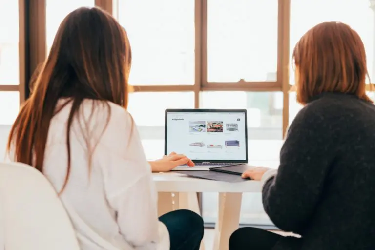 Two women looking at laptop screen | hoto by KOBU Agency on Unsplash
