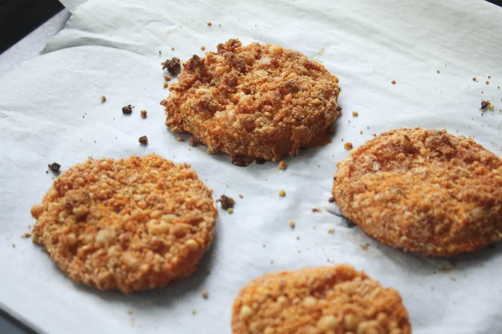 baked fried green tomatoes on parchment paper