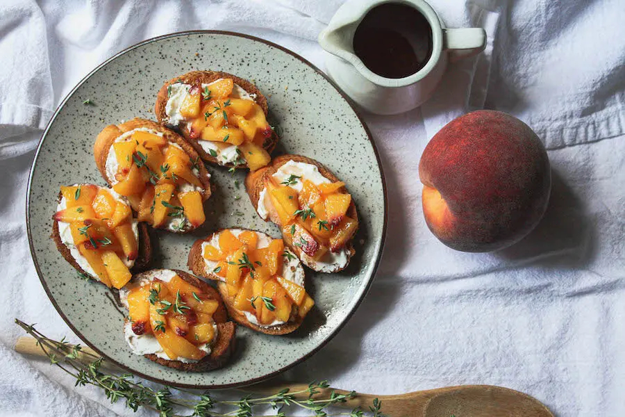 overhead image of peach crostini on table