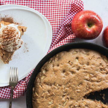 overhead image of apple cinnamon skillet cake with slice next to skillet