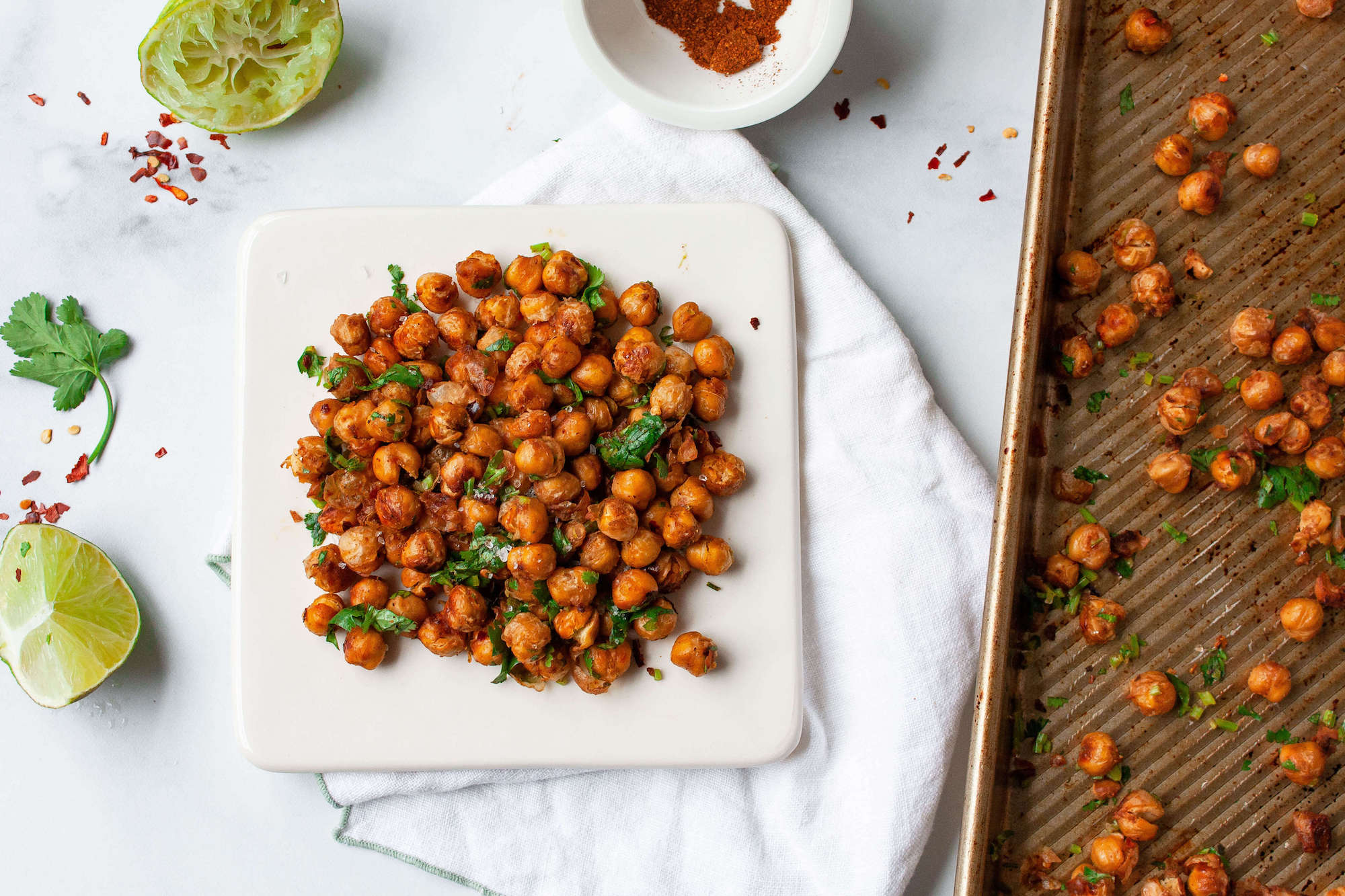 chili lime roasted chickpeas on plate with adjacent baking sheet | flexitarian diet