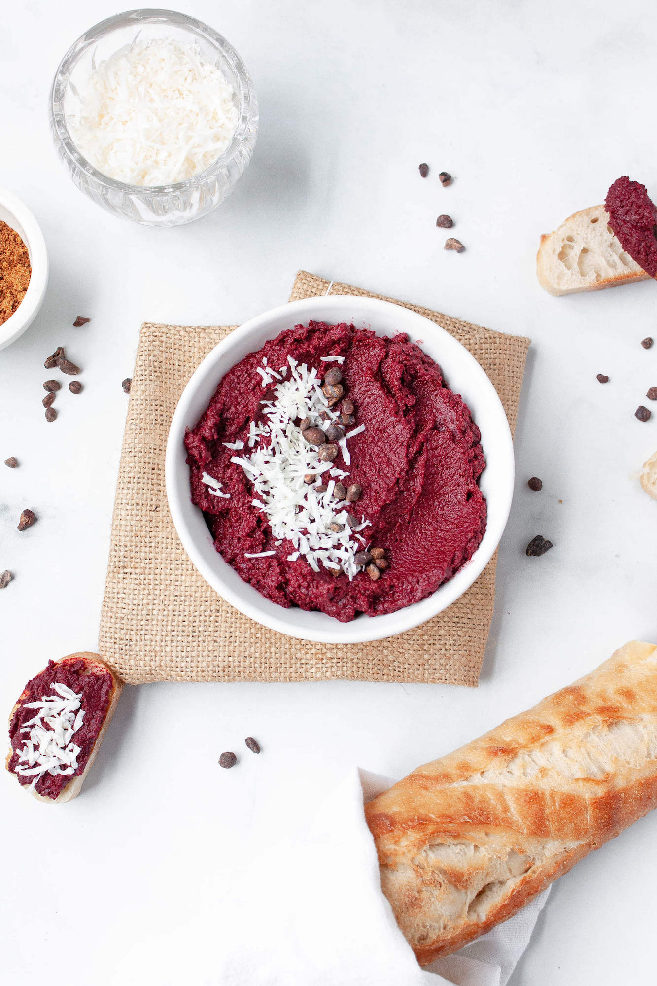 overhead image of roasted beet dessert hummus sprinkled with coconut shavings