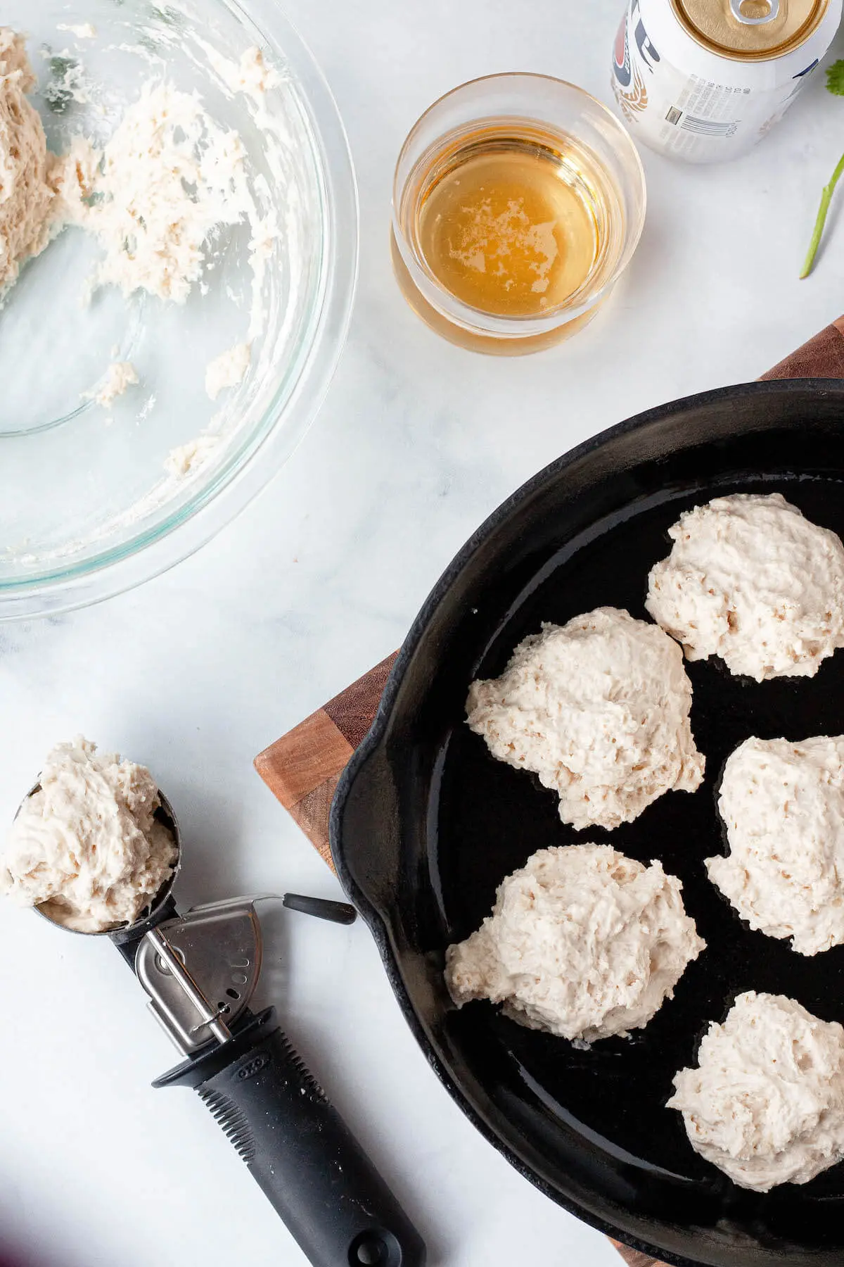 beer biscuit dough shaped into biscuits in cast iron skillet