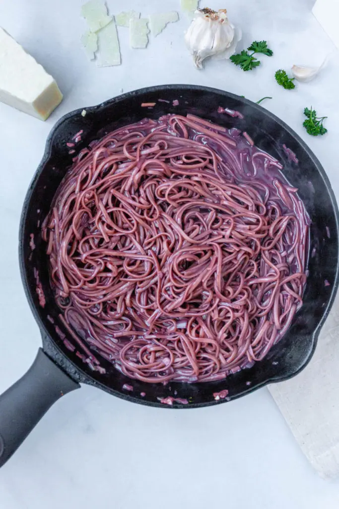 gluten free red wine pasta in a cast iron skillet