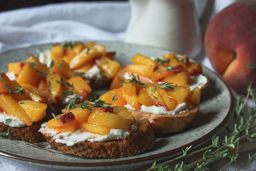 side angle of peach crostini on plate