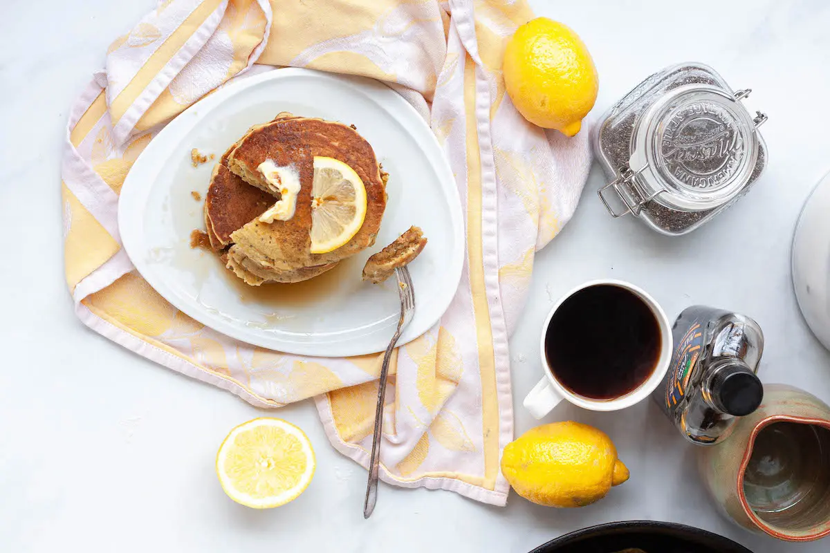 overhead image of lemon poppy seed pancakes and coffee on counter