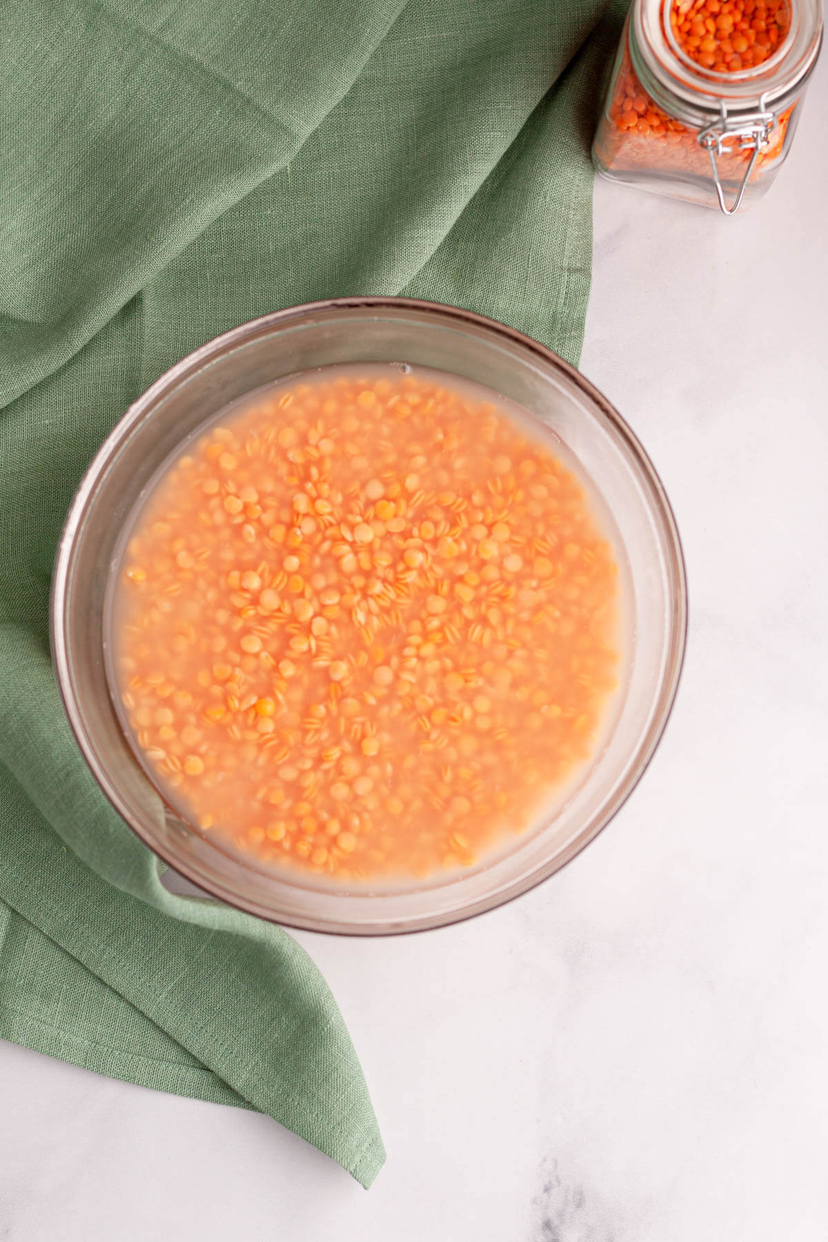 red lentils soaking in bowl with water