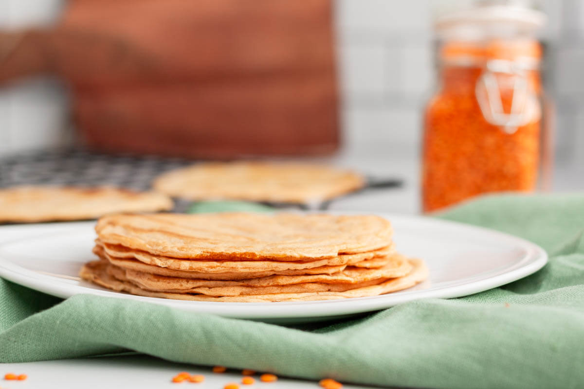 stack of red lentil tortillas on plate