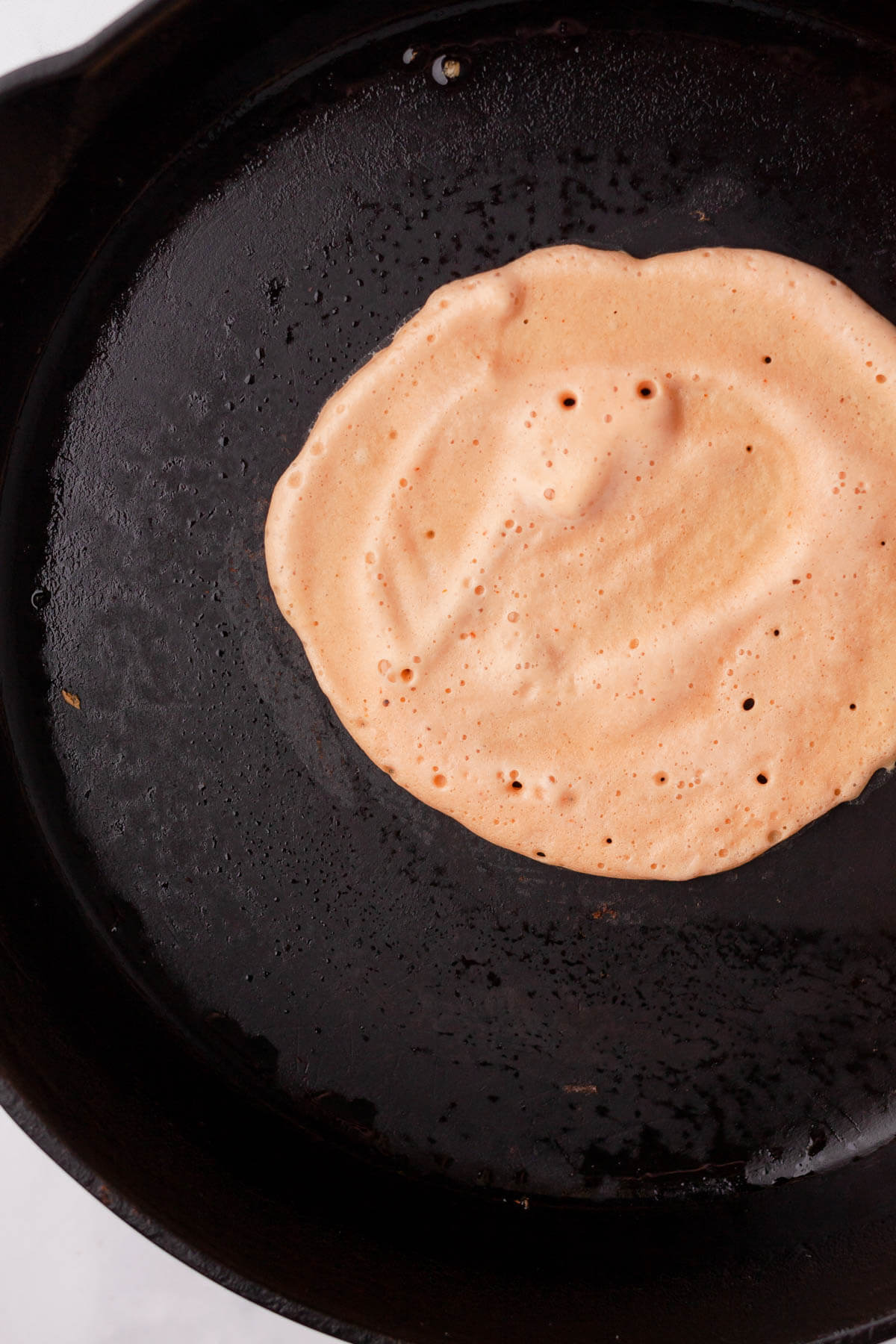 red lentil tortilla batter in cast iron skillet