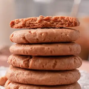 side image of stacked peanut butter cookies with bite taken from cookie on top