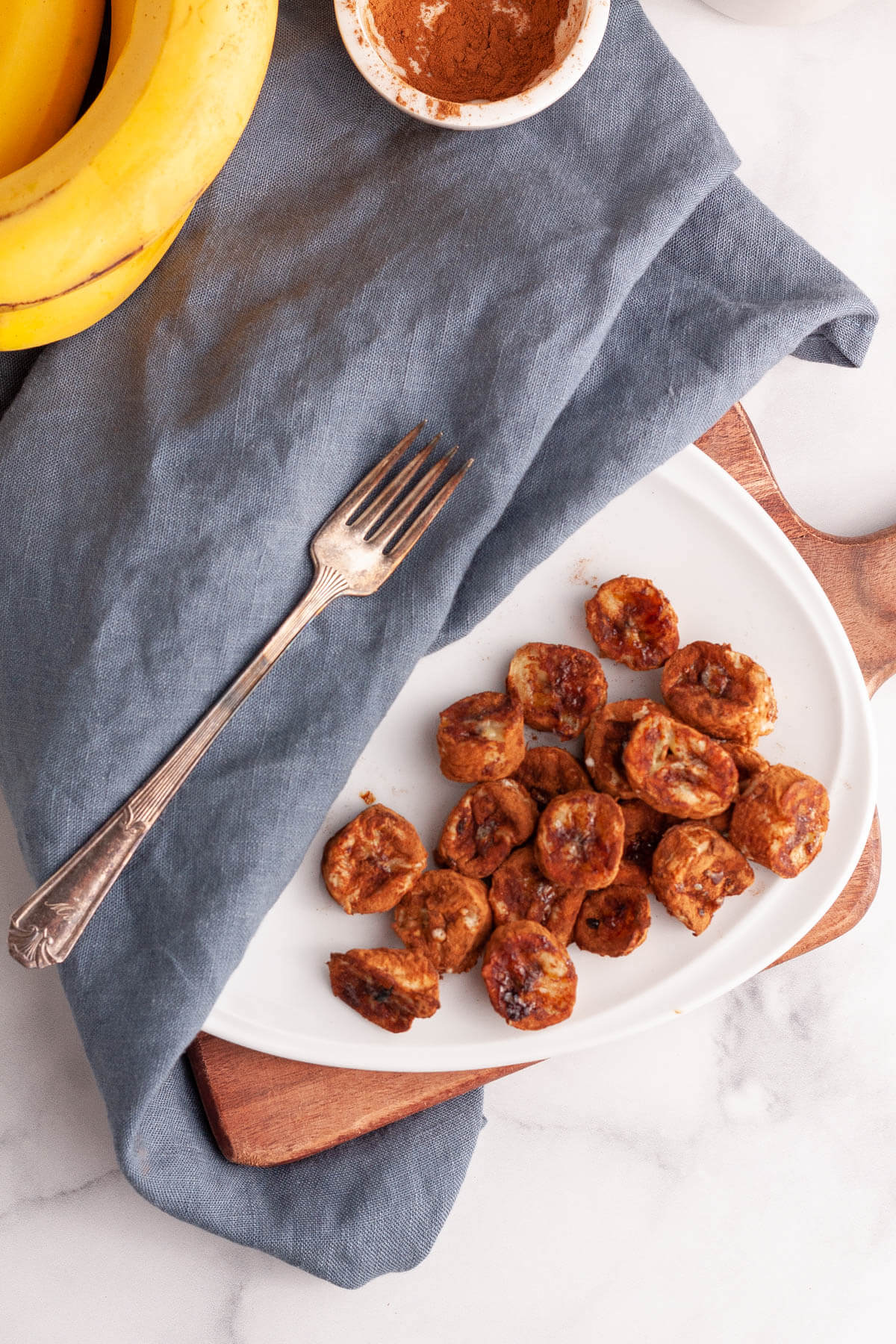 overhead image of air fryer bananas on plate with fork