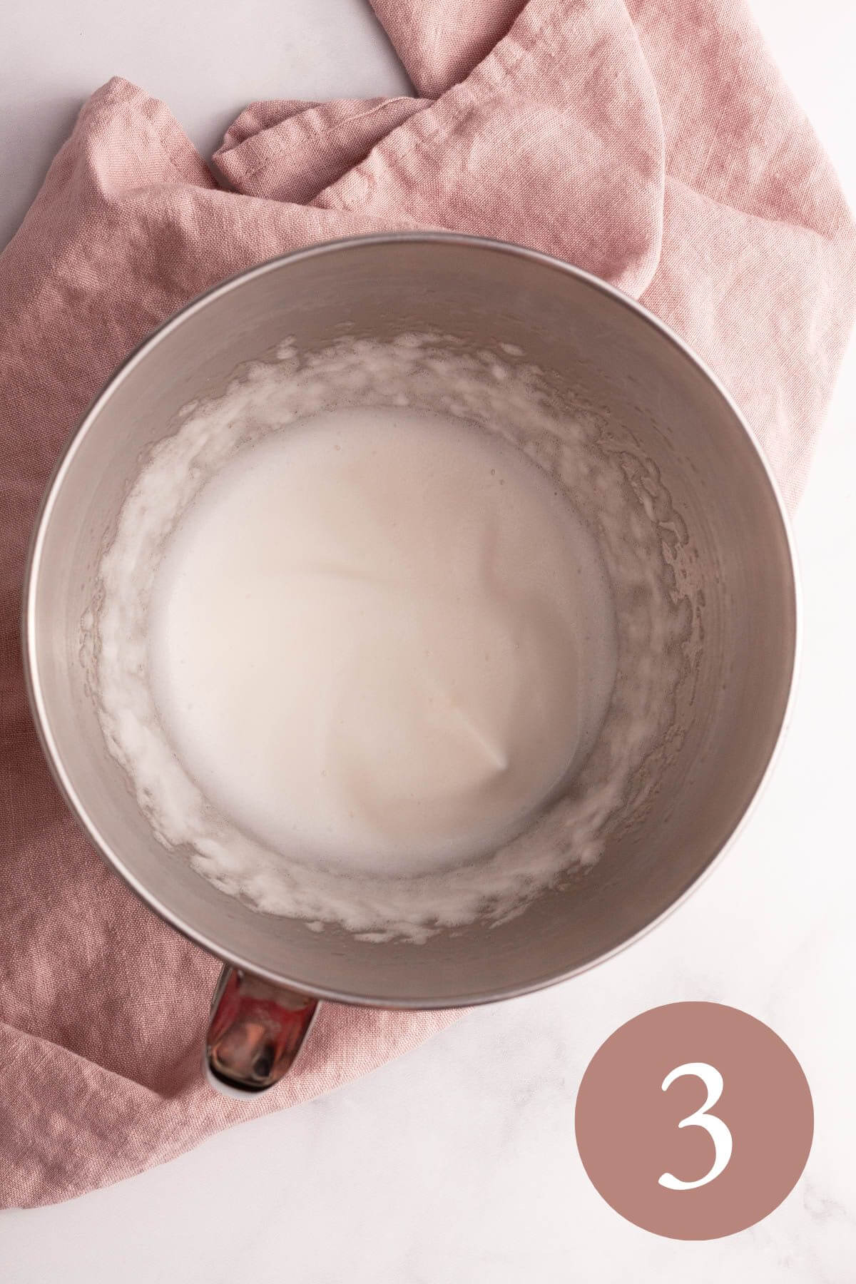 overhead image of whipped aquafaba in bowl