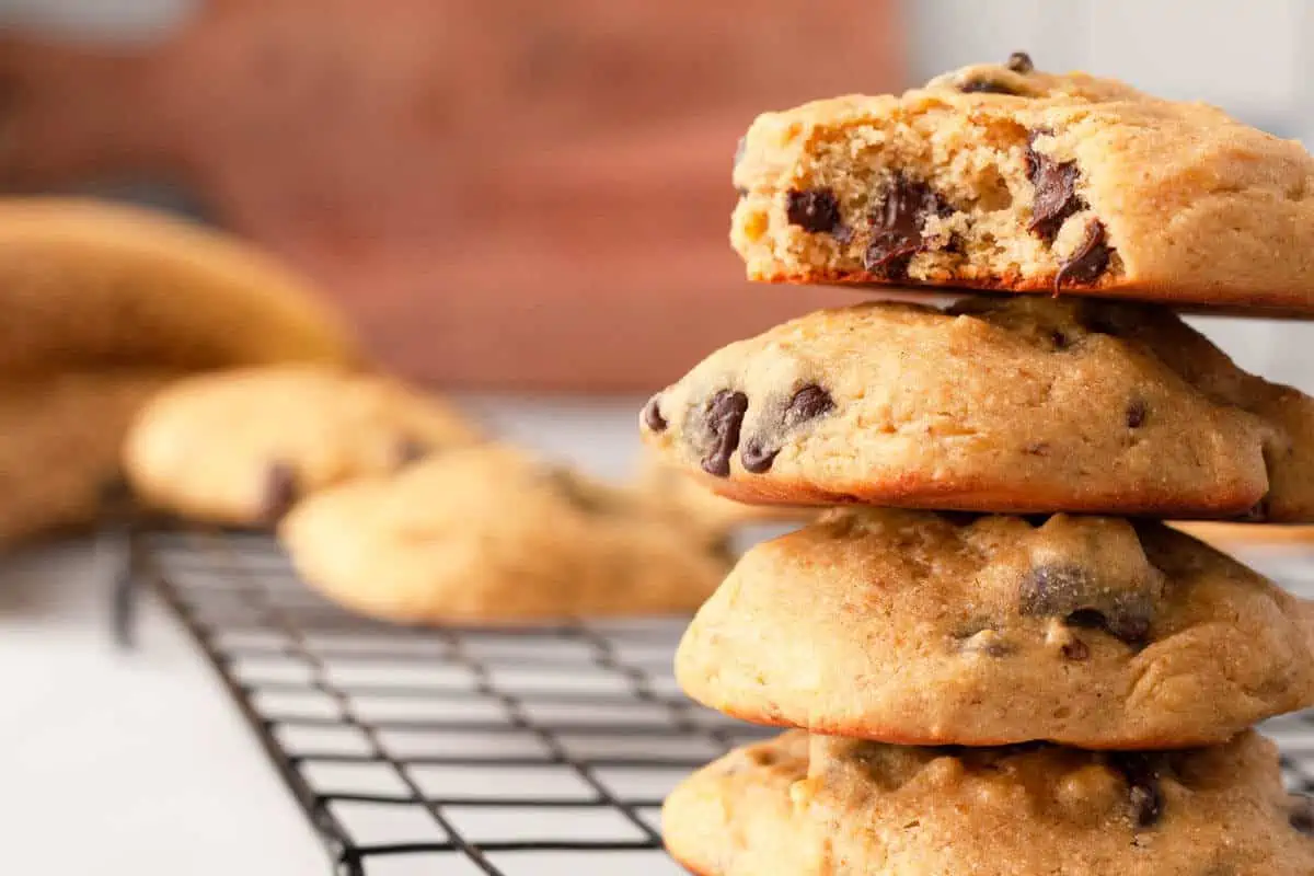 Stacked cookies on wire rack. Top cookie has bite removed.