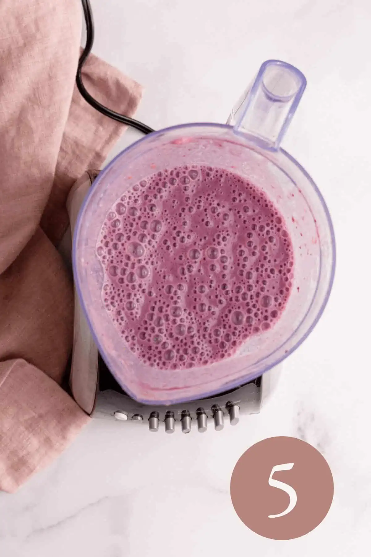 Overhead image of blackberry strawberry banana smoothie blended before topping with fruit