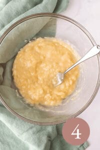 Overhead image of mashed bananas in glass bowl