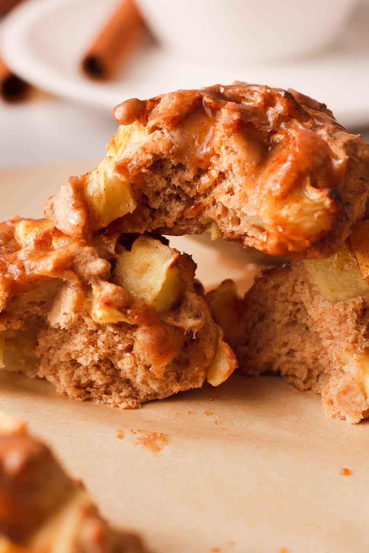 side image of apple fritters with bites to show interior texture