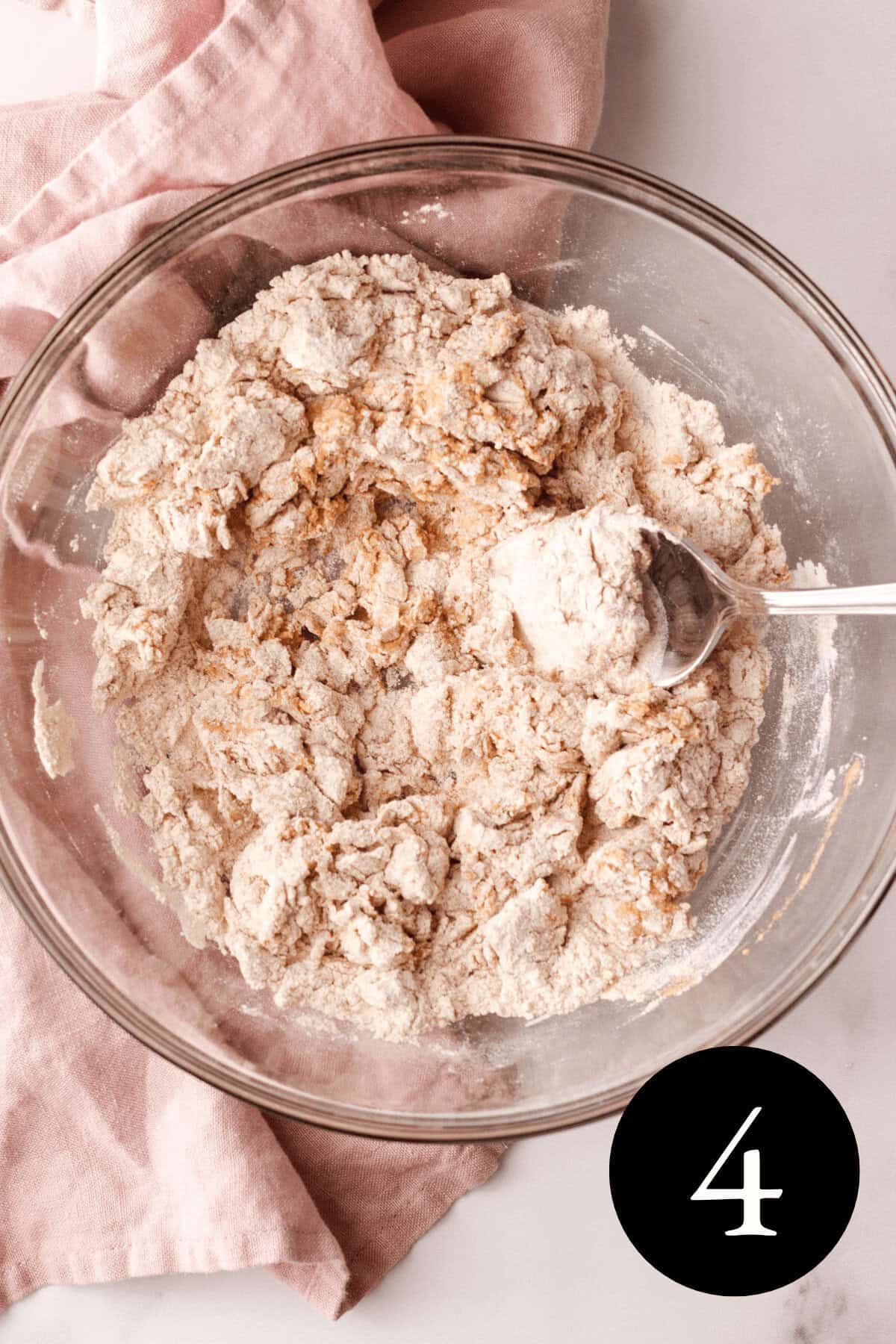overhead image of fritter dough in bowl with the wet and dry ingredients barely combined