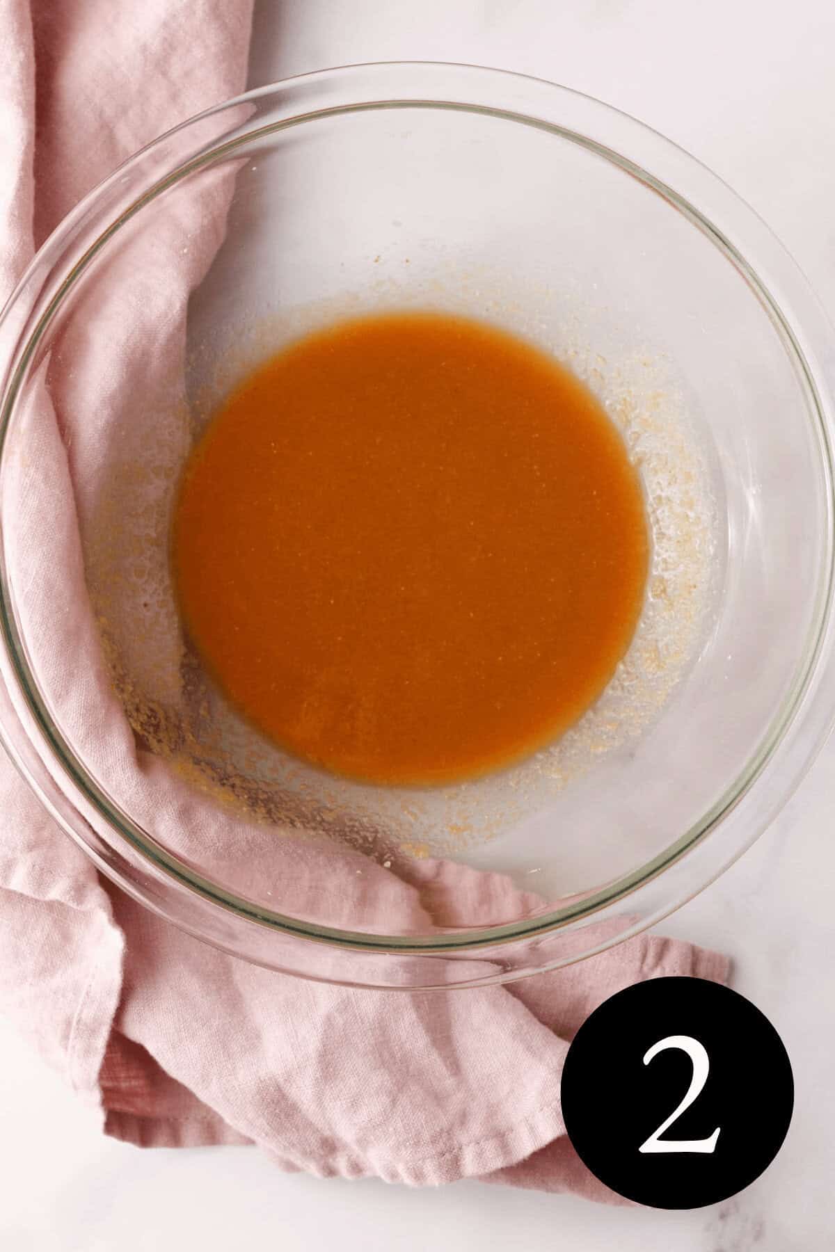 overhead image of wet ingredients mixed together in glass bowl