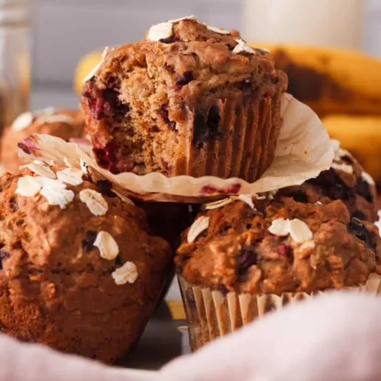 side image of stacked muffins with the top muffin missing a bite