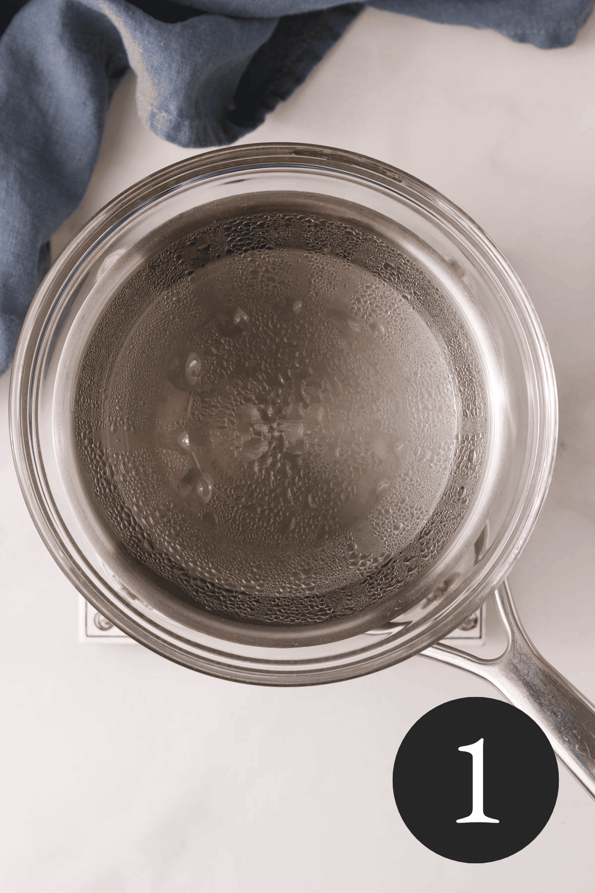 overhead image of coconut oil melted in double broiler