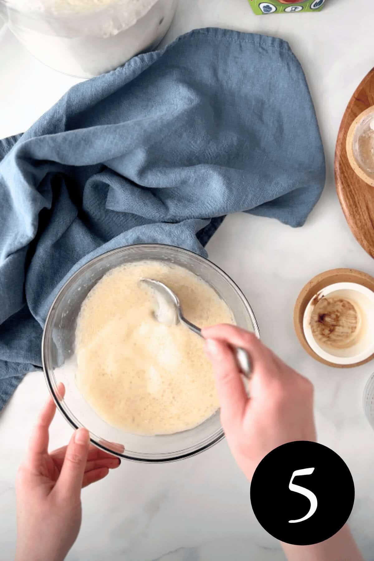 overhead image of person stirring together wet ingredients