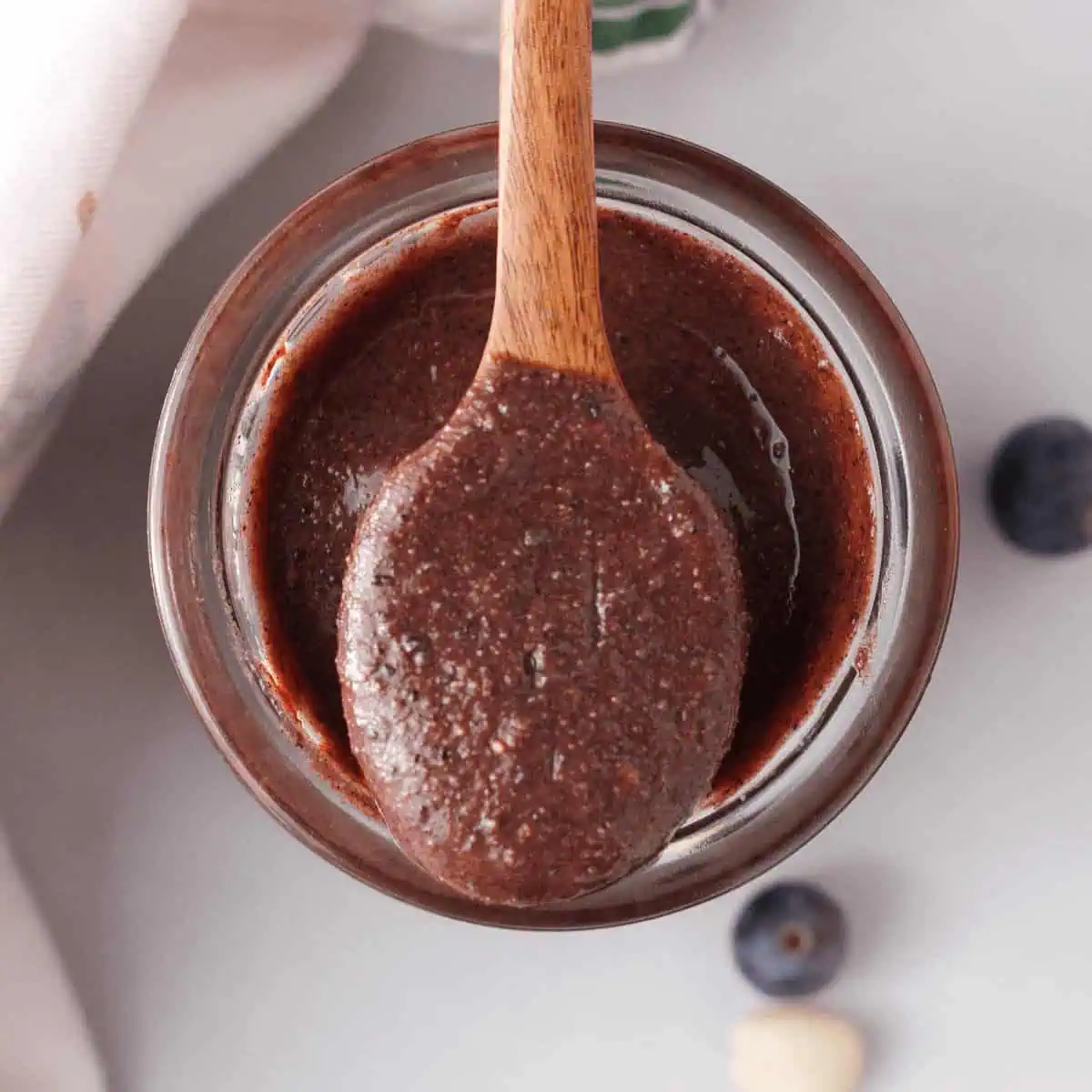 overhead image of spoon with blueberry peanut butter resting on jar