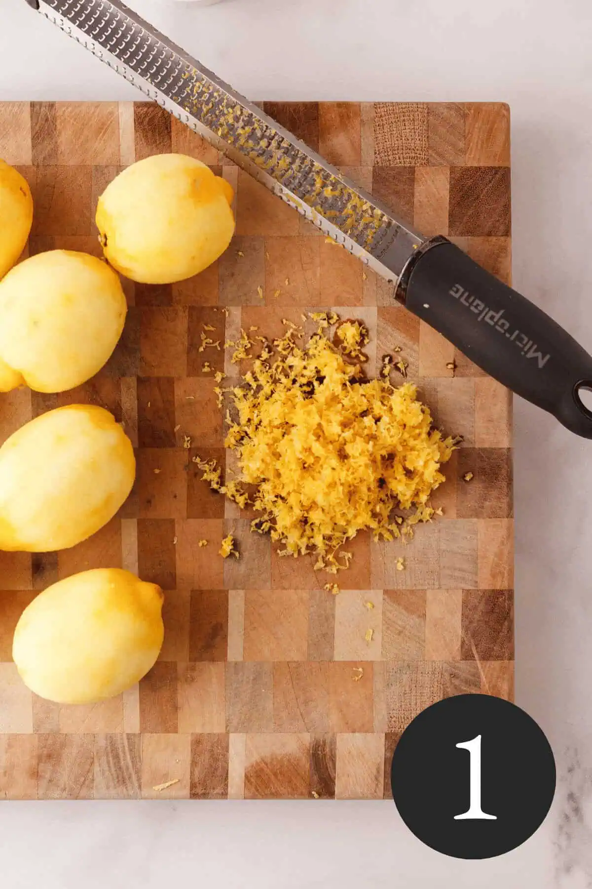overhead image of zested lemons on cutting board