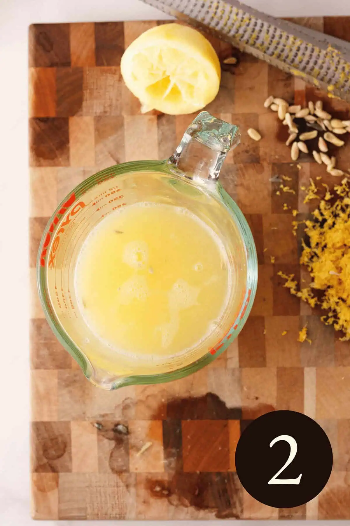 overhead image of freshly squeezed lemon juice in measuring cup