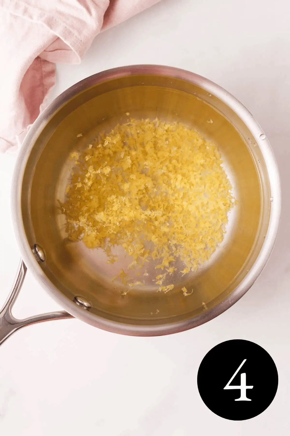 overhead image of lemon zest and water in saucepan