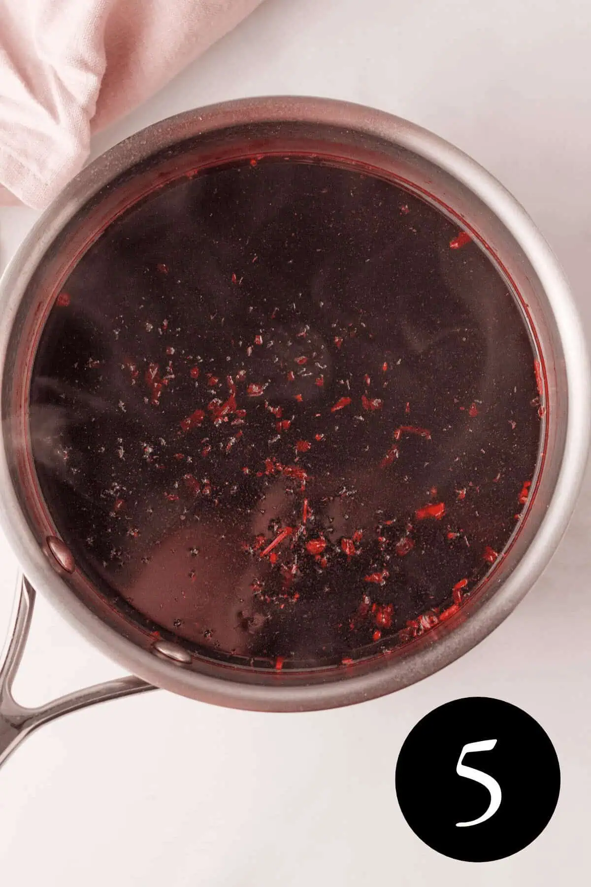 overhead image of hibiscus and stevia in saucepan with water