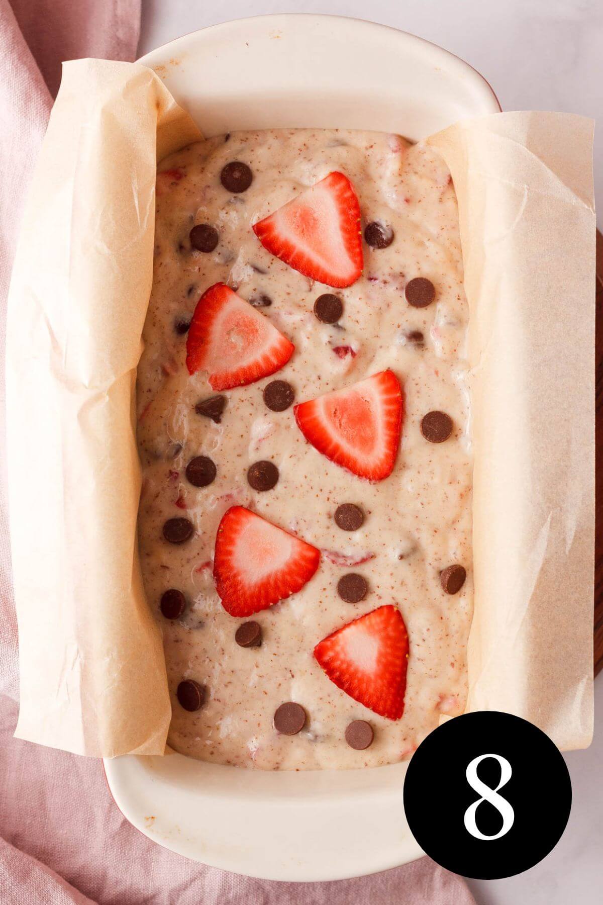 overhead image of dough in loaf pan with toppings added
