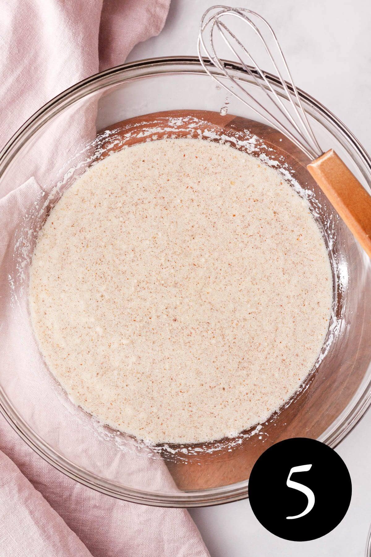 overhead image of whisked wet ingredients in glass bowl