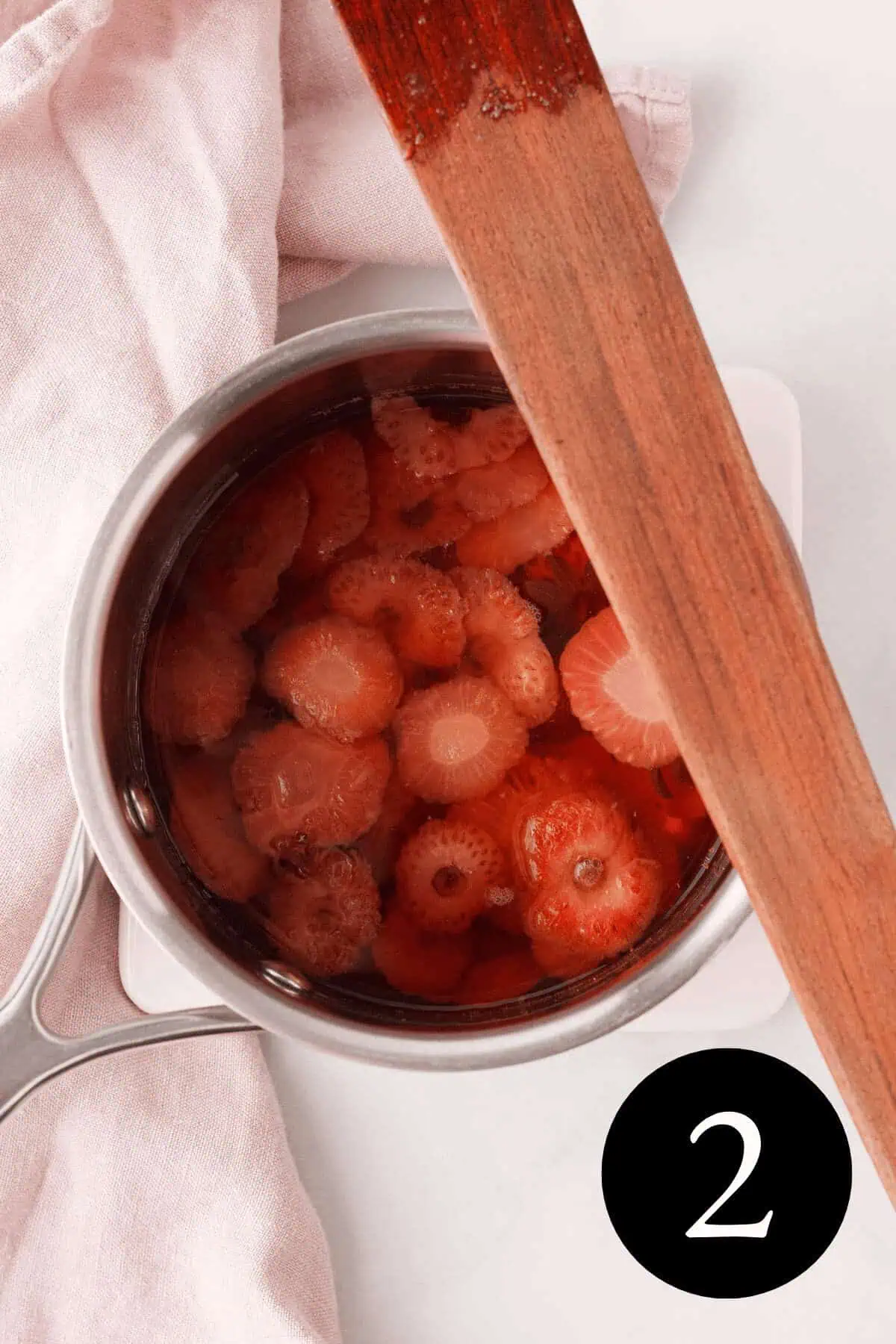 overhead image of strawberry tops after losing color from simmering