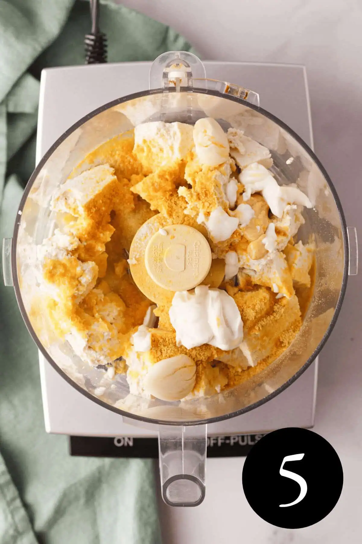 overhead image of vegan whipped feta ingredients in food processor bowl before blending