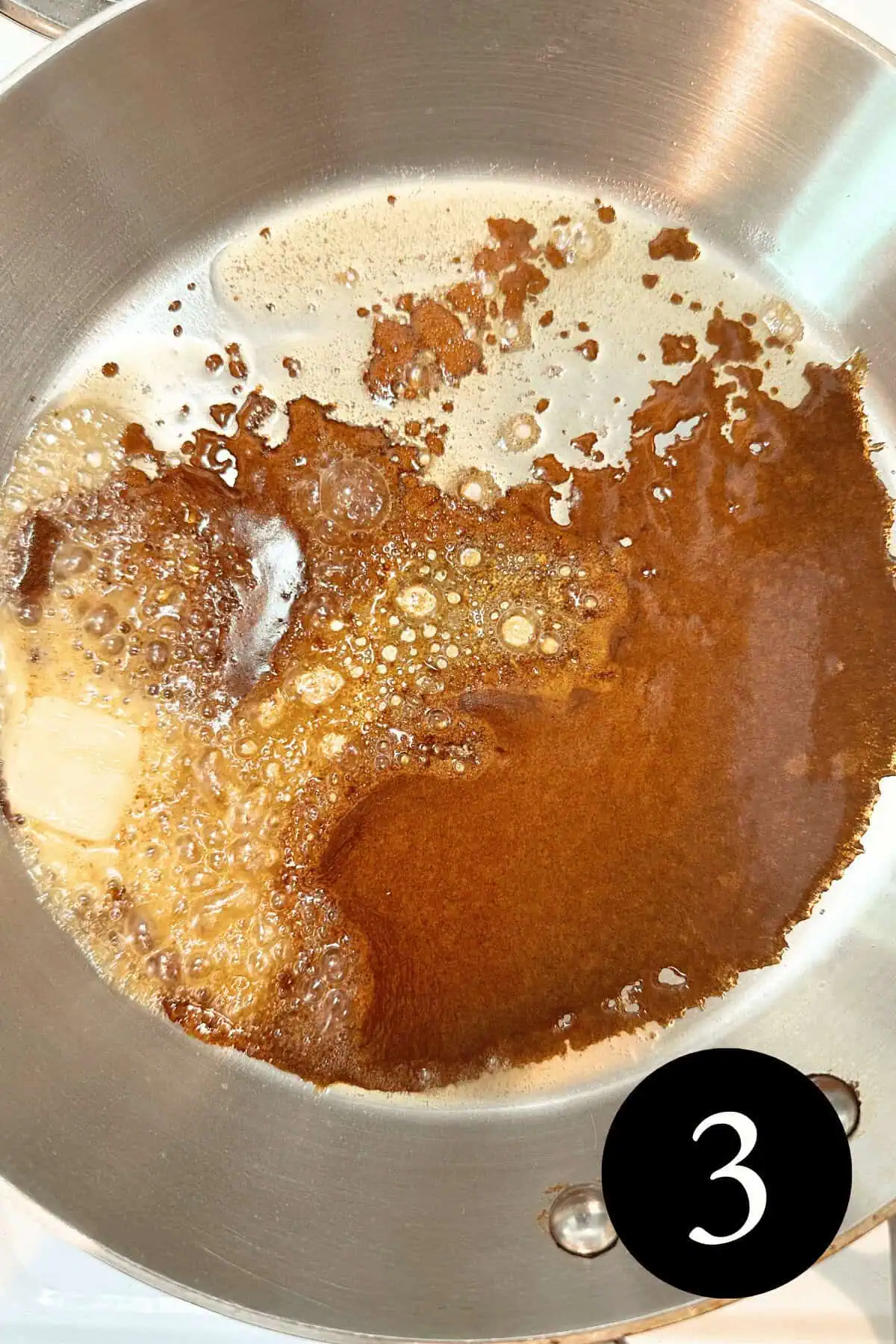 overhead image of butter melting into caramel covering bottom of skillet and number three in the bottom right corner