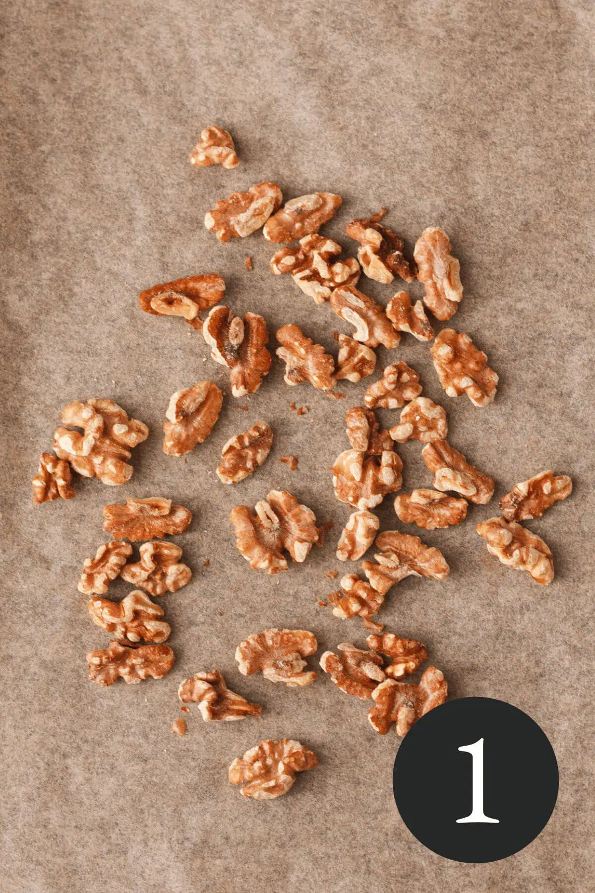 overhead image of toasted pecans on parchment paper