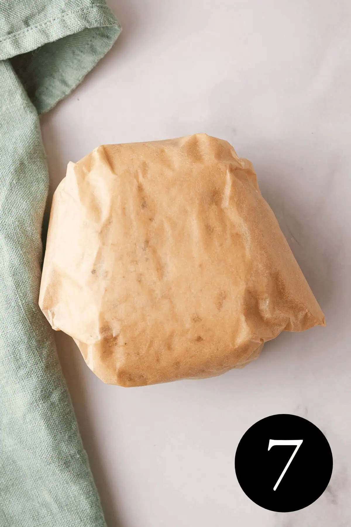 overhead image of dough wrapped in parchment paper