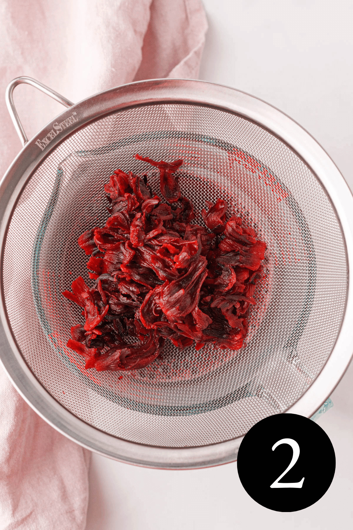 overhead image of hibiscus in strainer