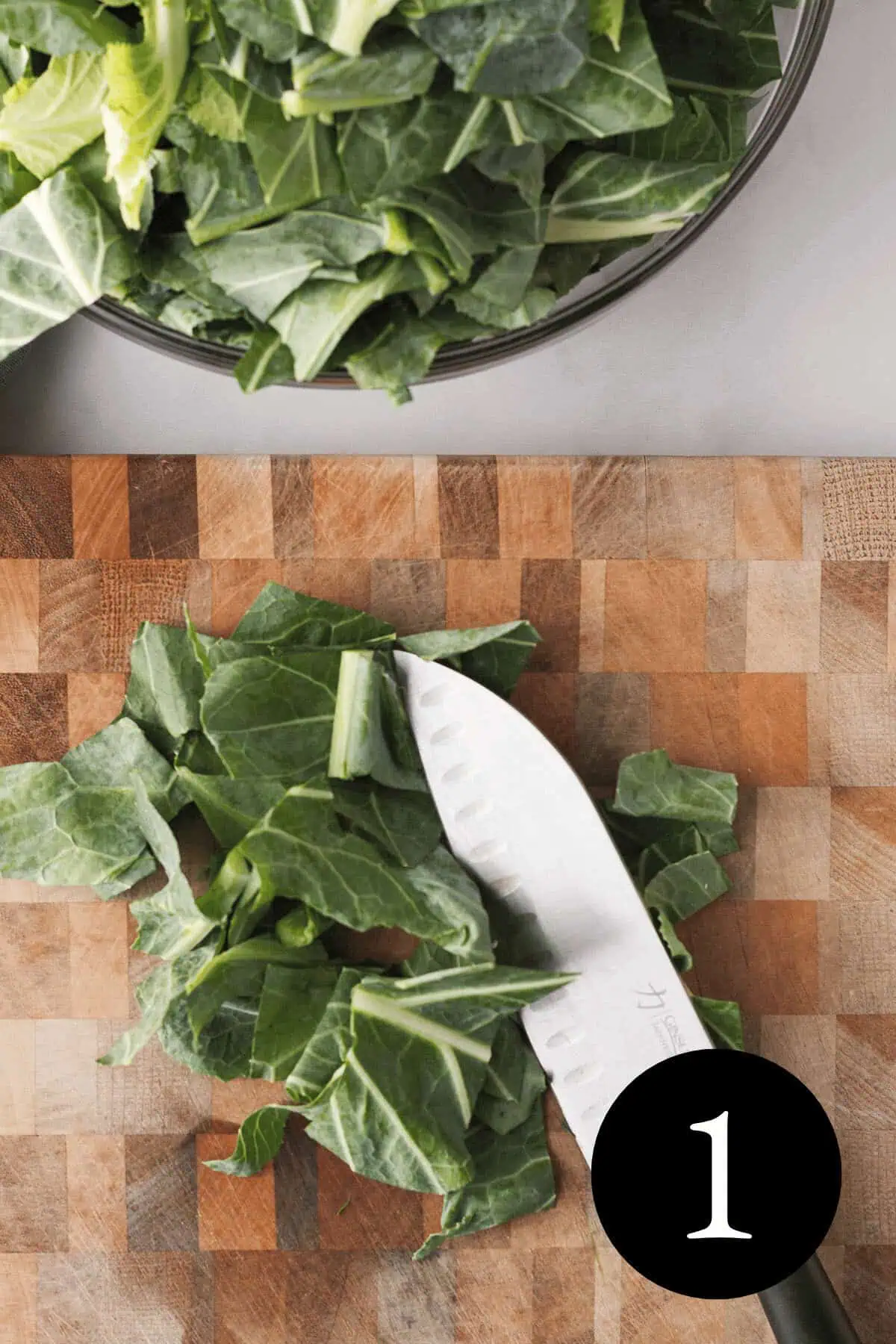 overhead image of knife with chopped collard greens on cutting board with bowl of chopped greens at the top with number 1 in bottom right corner