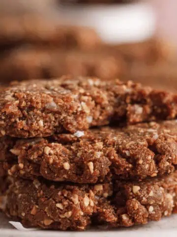 stack of three peanut butter date cookies with bite taken out of top cookie