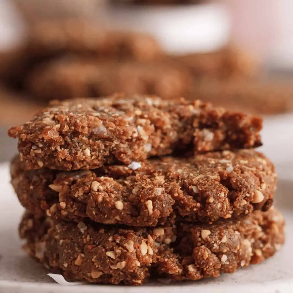stack of three peanut butter date cookies with bite taken out of top cookie