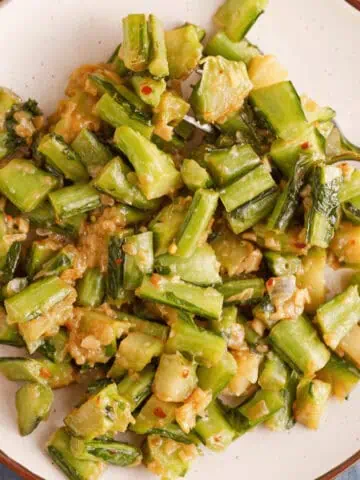 overhead image of cooked collard green stems on plate