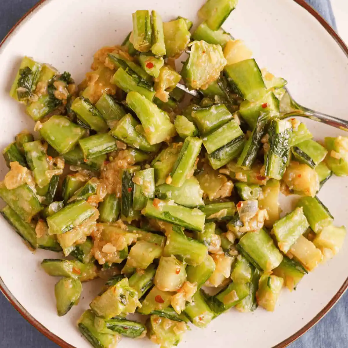overhead image of cooked collard green stems on plate