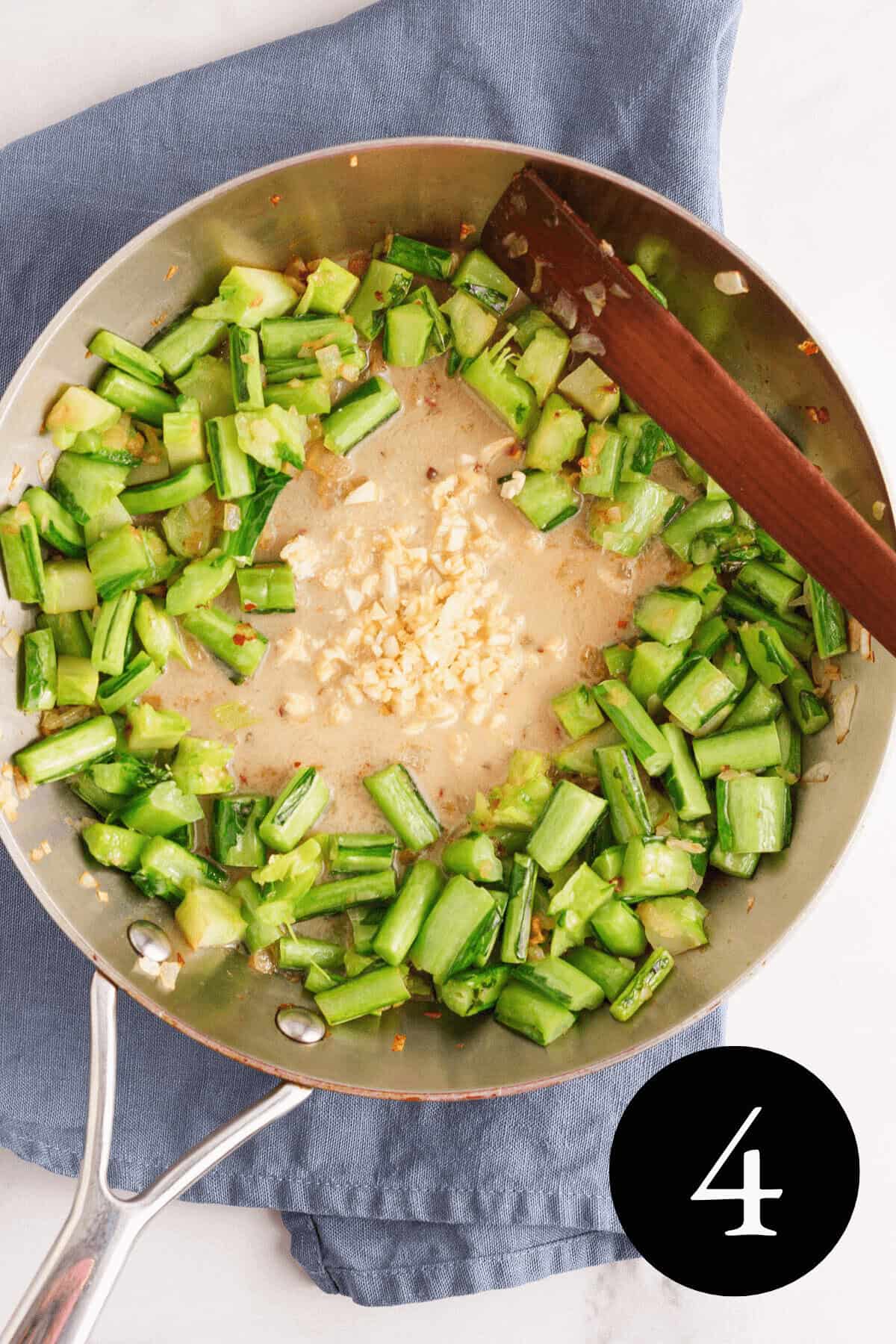 overhead image of collard green stems in the skillet pushed to the side with garlic and miso sauce in the center and number four in the bottom right corner