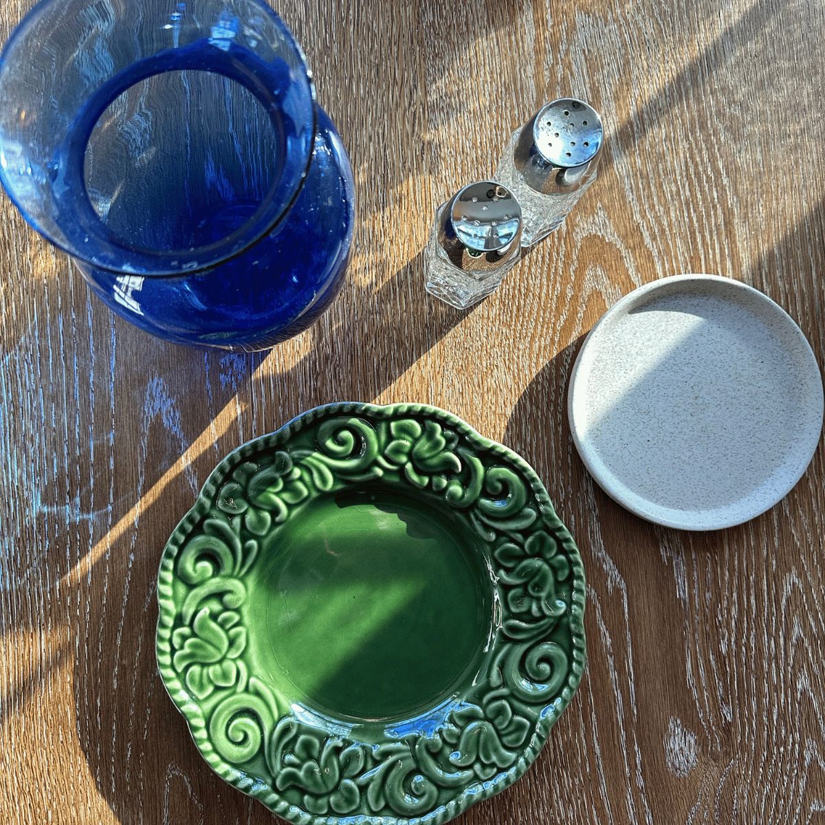 overhead image of vase, plates, and salt and pepper shakers bought at an estate sale