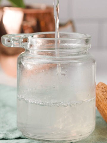 closeup of sugar free simple syrup pouring into glass container