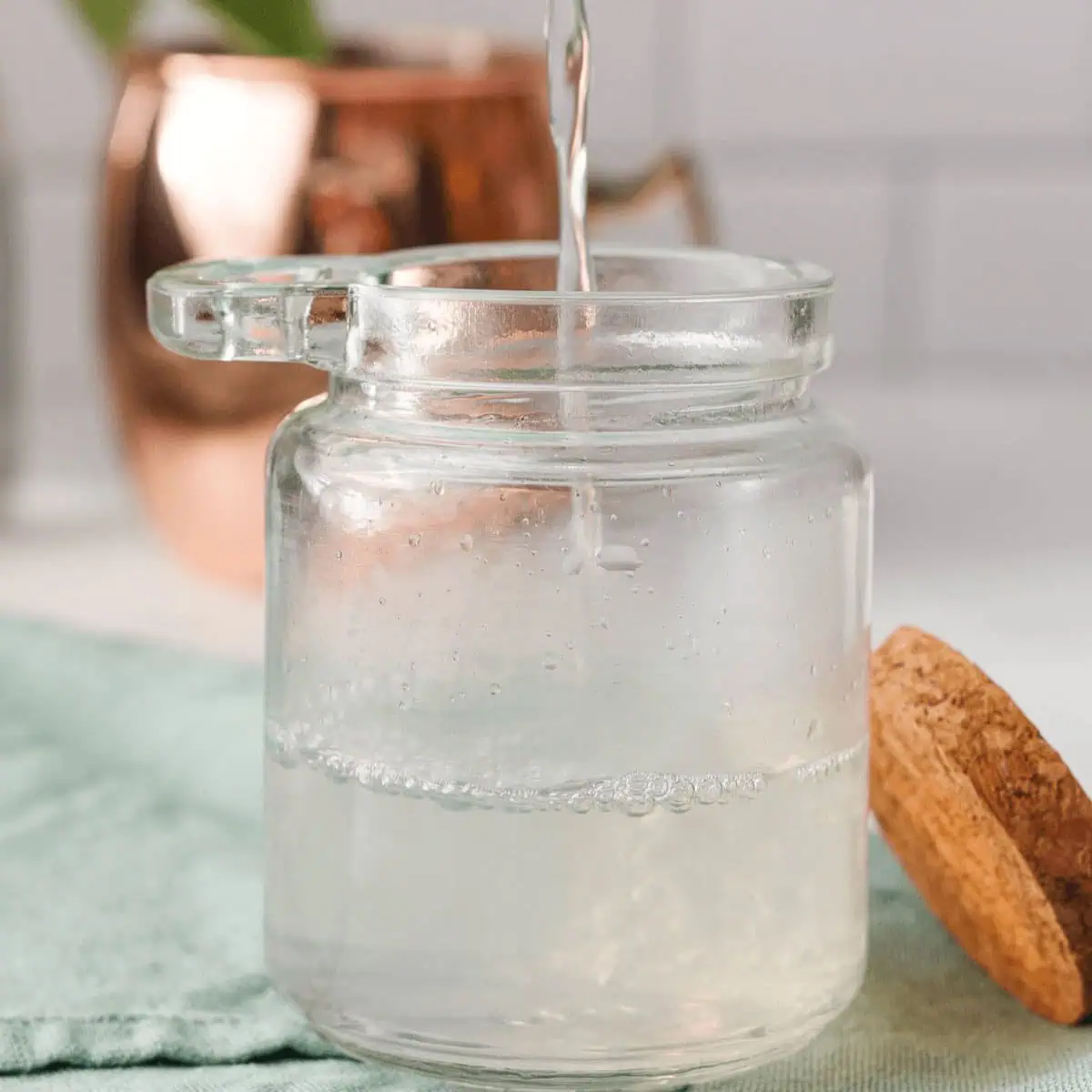 closeup of sugar free simple syrup pouring into glass container