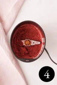 overhead image of blended blackberry powder in spice grinder with number 4 in the bottom right corner