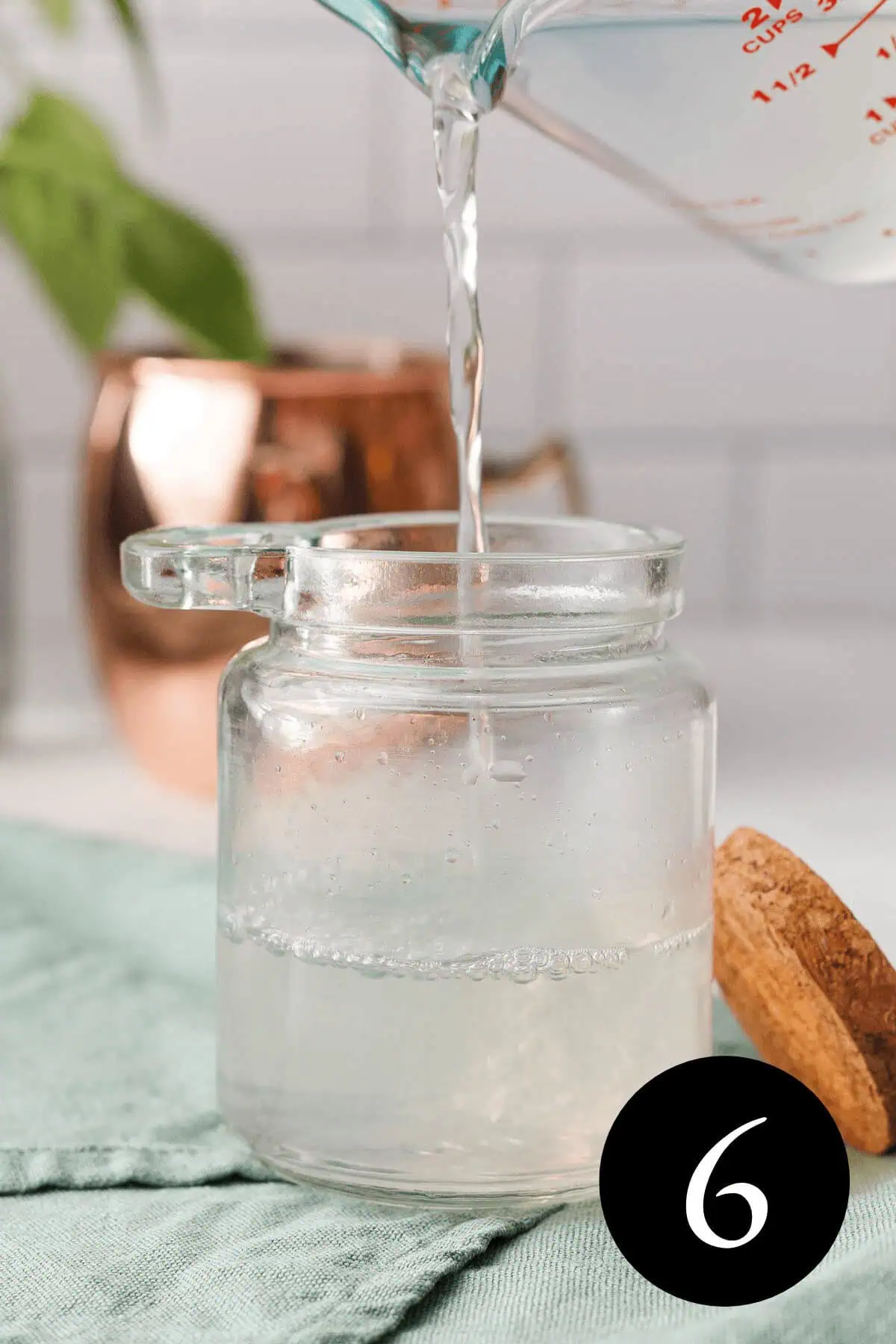 closeup of sugar free simple syrup pouring into glass jar with number six in bottom right corner